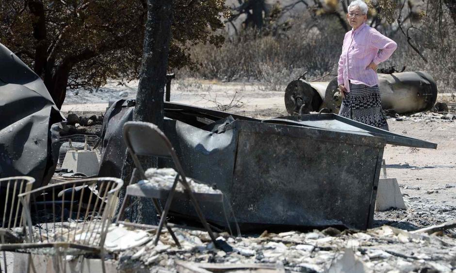 Ki Jo So returns to her home and property burned by the Blue Cut Fire off of the 138 for the first time Monday August 22, 2016. So, who has lived on the property for 13 years with her family, had no insurance. Photo: Will Lester