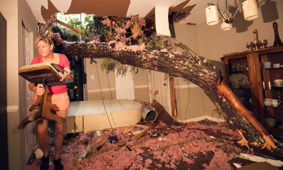 Storm victim, Susan Griffin, saves a piece of furniture from the home she was renting after a tree fell on the home in Ocala, FL. Photo: Doug Engle, Star-Banner