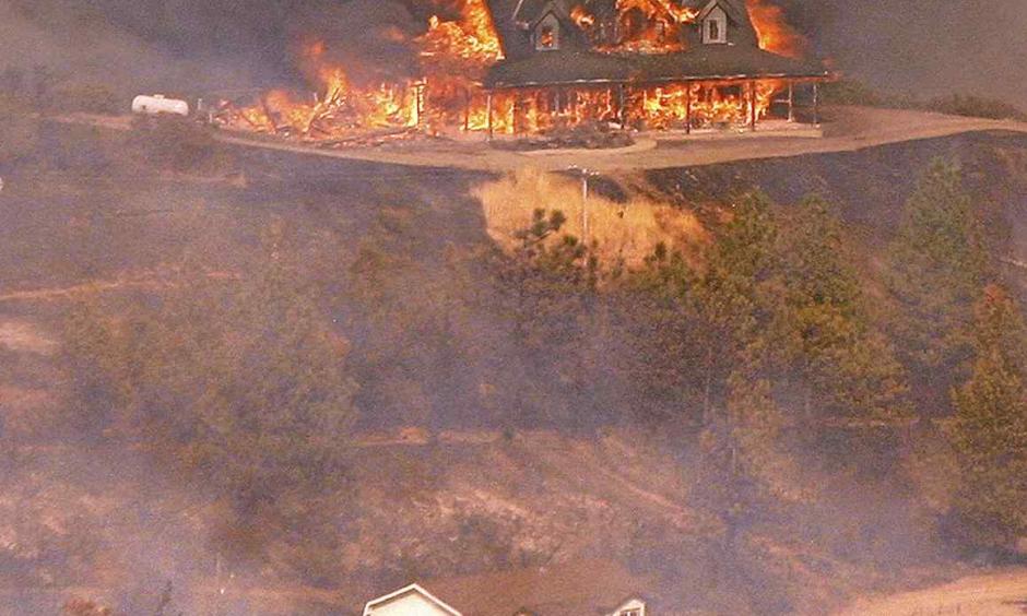 A structure burns near Loma Prieta Road and Loma Chiquita Road in Santa Clara County on Monday. Photo: Vern Fisher - Monterey Herald