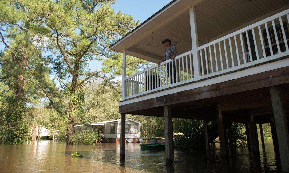 Mitch Townsend stands on the porch of his home as floodwaters from Little Swift Creek rise in Vanceboro on Oct. 10, 2016. Hurricane Matthew xxaused some major flooding in wetern parts of Craven County and throughout the eastern part of the state, flooding that even surprised forecasters, according to a report on the storm. Photo: Sun Journal File