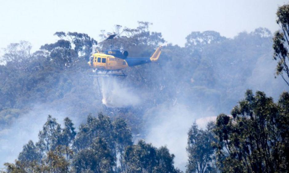 A helicopter helps the effort to control a fire in Sunbury on Christmas Day. Photo: Simon O'Dwyer
