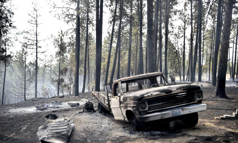 A charred truck is seen near the home of Julie Thayer and her husband, Art, on South Yale Road near Valleyford, Spokane County, on Monday. The Thayers had been hiking over the weekend and returned home. Photo: Tyler Tjomsland, The Spokesman-Review