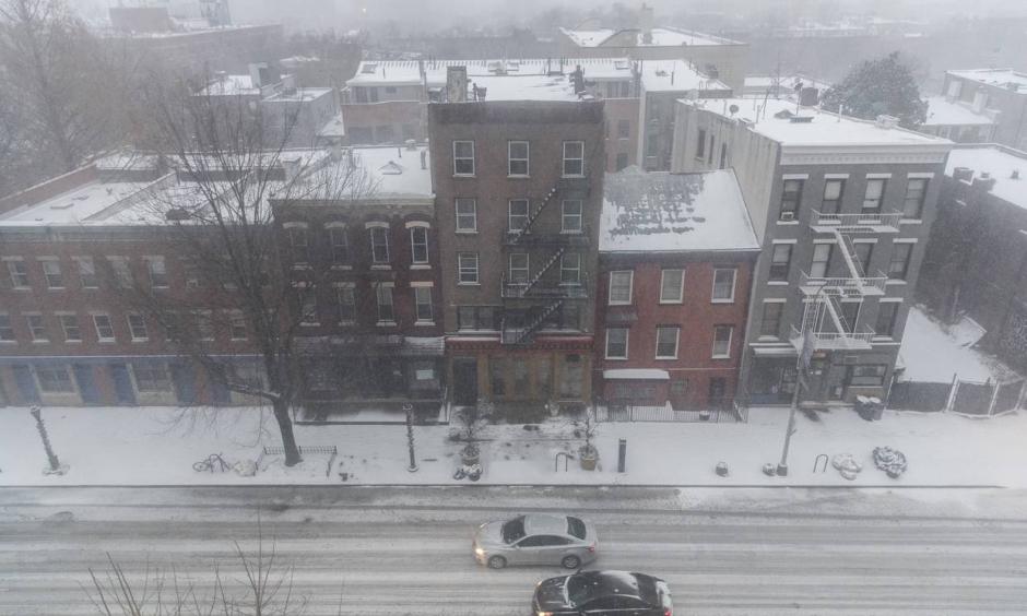 Vehicles driving through the snow on Atlantic Avenue in the Brooklyn borough of New York City on Thursday. Photo: Drew Angerer, Getty Images
