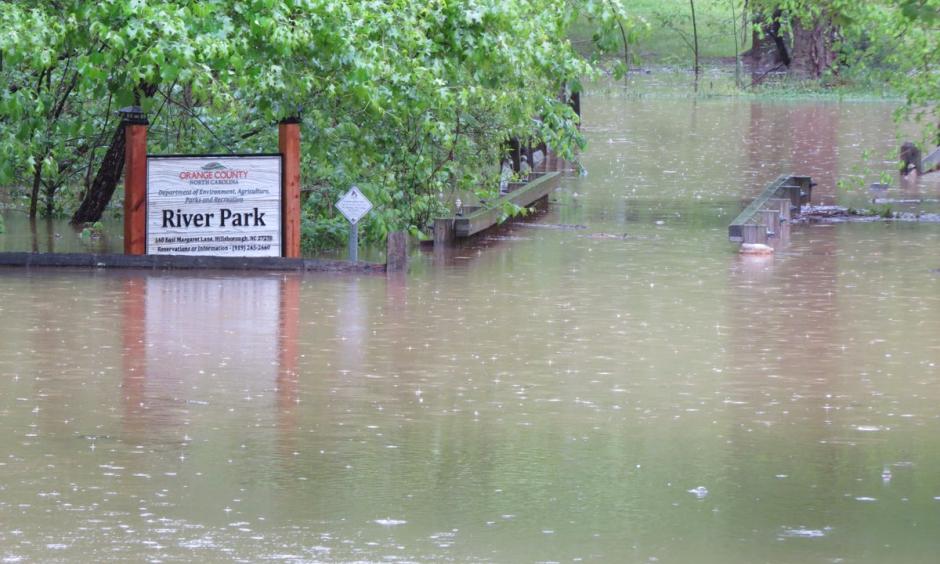Entrance to River Park in Hillsborough. Eno River is almost above the foot bridge railings. Photo: Orange County NC Gov, @OCNGOV, Twitter