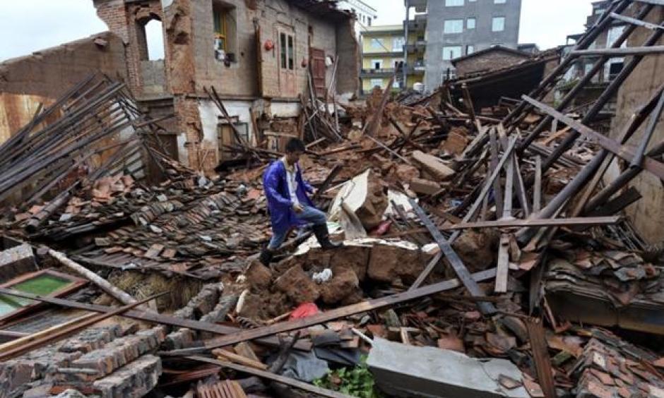 In this July 9, 2016 photo, a villager walks around a destroyed house, after torrential rainfall brought by typhoon Nepartak, in Lingcuo village of Xindu Township in Putian, southeast China's Fujian Province. Typhoon Nepartak weakened to a strong tropical storm Saturday as it lashed China's east coast, bringing powerful winds and heavy rains that toppled houses and inundated roads. Photo: Zhang Guojun/Xinhua News Agency via AP