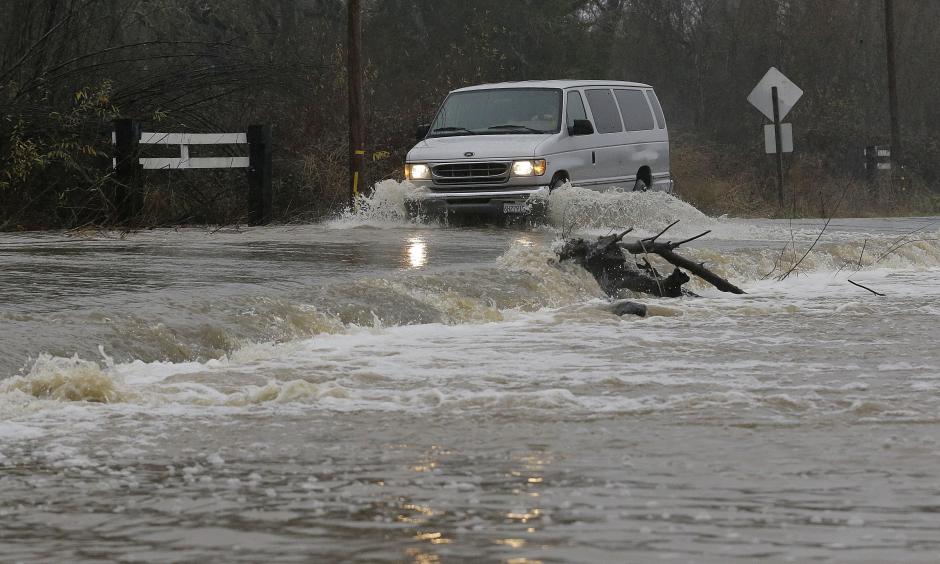 A van drives through flooded water on Green Valley Road in Graton, Calif., Saturday, Jan. 7, 2017. On the California coast, weather forecasters anticipate a storm surge from the Pacific called an atmospheric river to dump several inches of rain from Sonoma to Monterey counties, and up to a foot in isolated places in the Santa Cruz mountains. Photo: Jeff Chiu, AP