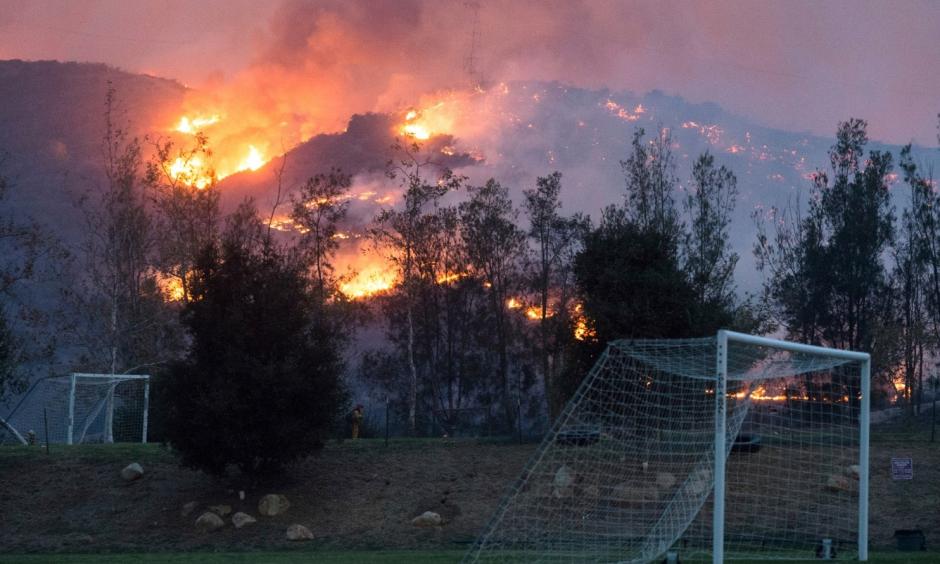 Flames from a wildfire consume the mountainside near the Cate School campus in Carpinteria, Calif., on Sunday. Photo: Kenneth Song, Santa Barbara News-Press via AP