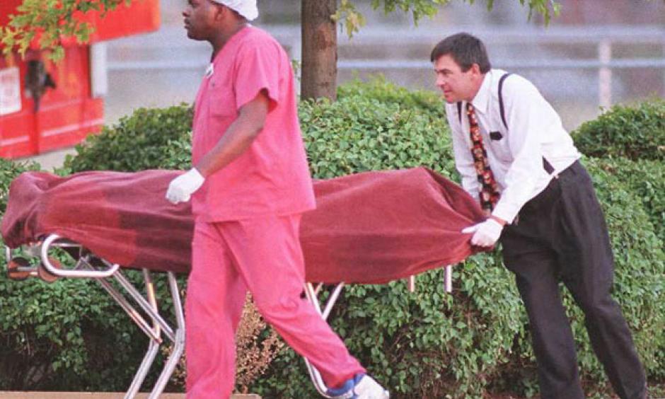 Medical examiners remove a body during the heat wave. Photo: Slate