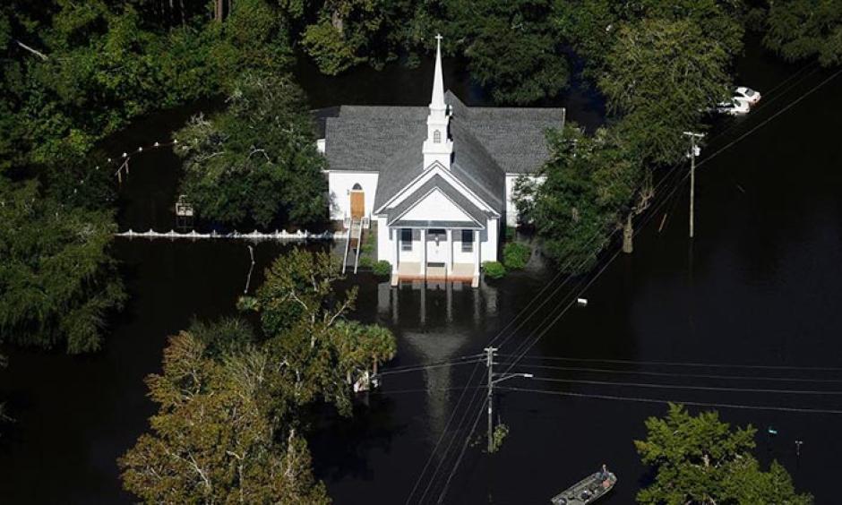 A boat passes a church in Nichols, S.C., Monday, Oct. 10, 2016. Photo: Rainier Ehrhardt, AP