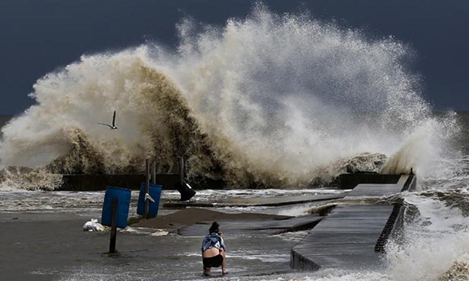 Sydney Schultz takes photos of waves crashing next to Rollover Pass as Tropical Storm Cindy approaches the coast Wednesday, June 21, 2017 on the Bolivar Peninsula, Texas. Photo: Michael Ciaglo, Houston Chronicle via AP