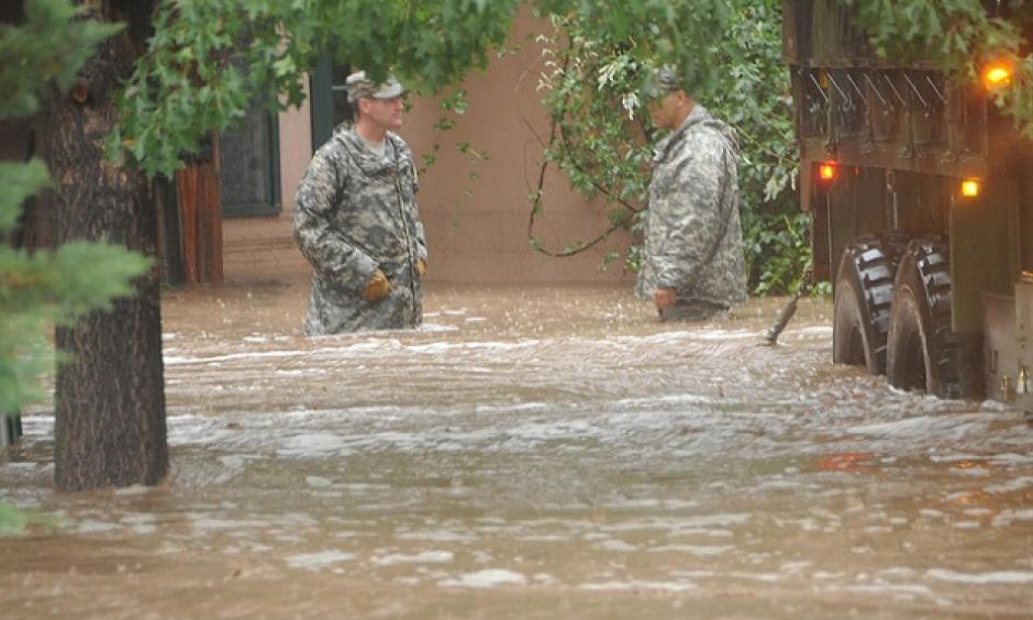 Two Colorado National Guardsmen waist deep in Boulder floodwaters. Photo: Colorado National Guard/Flickr