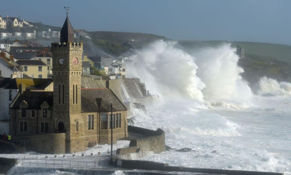 Waves break around the church in the harbor at Porthleven, Cornwall, as post-tropical cyclone Ophelia hits the UK and Ireland. Photo: Ben Birchall, PA Images
