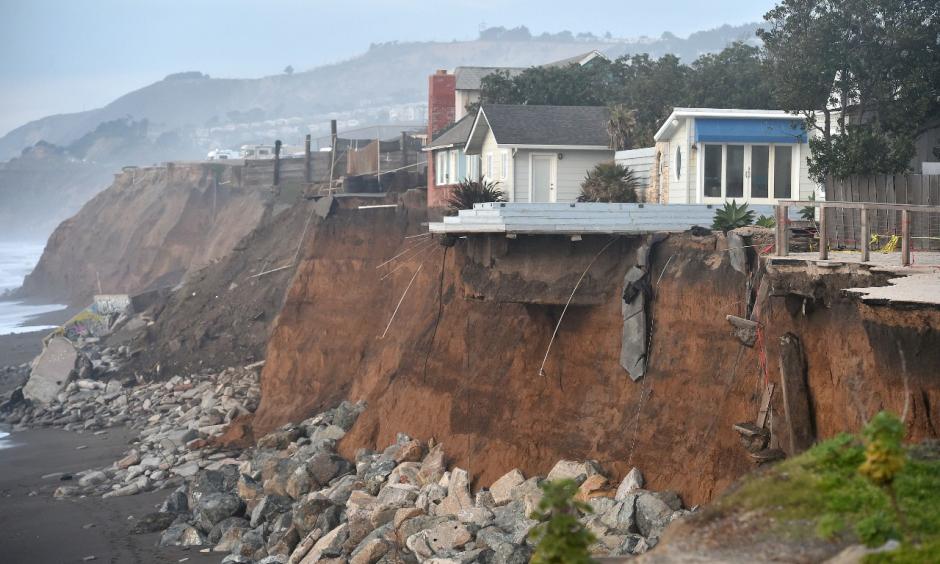 Sections of land are seen missing from coastal properties in Pacifica, California after El Niño-related storms on January 26, 2016. Photo: Josh Edelson, Getty Images