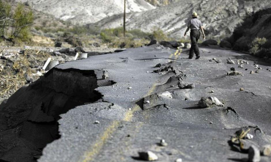 A 100-yard-long section of newly paved Highway 267 in Grapevine Canyon, a two-lane road designed to withstand severe flooding, was lifted up by roiling water and then slammed down on boulders in Death Valley National Park. (Brian van der Brug / Los Angeles Times)