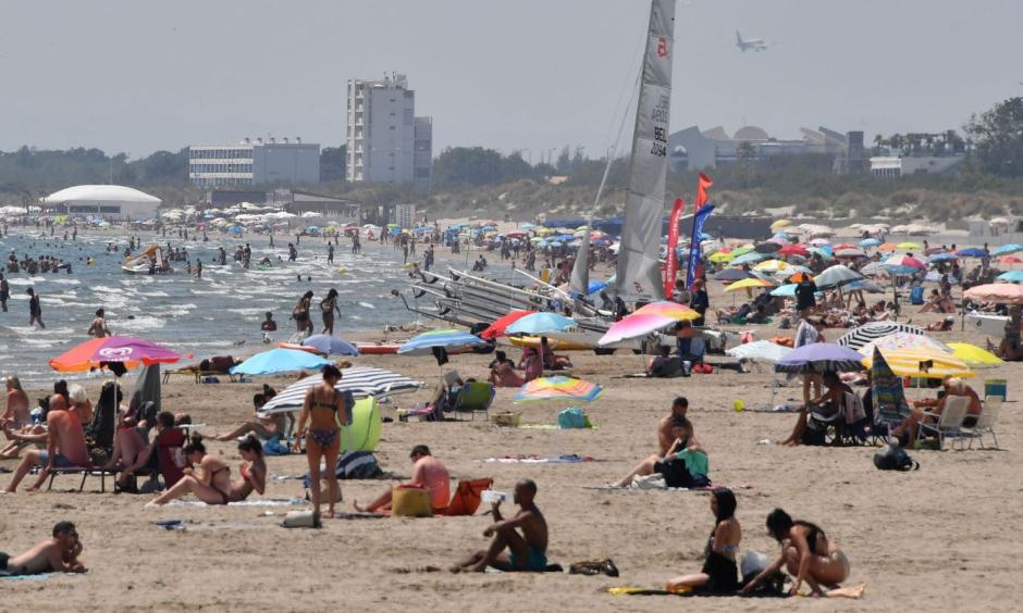 People sit on a beach in La Grande Motte, southern France, on June 28. Credit: Pascal Guyot, AFP