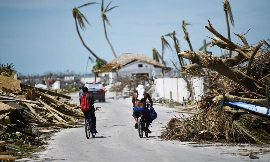 Residents pass damage caused by Hurricane Dorian in Marsh Harbour, Great Abaco Island in the Bahamas. Photo: Brendan Smialowski, AFP/Getty Images