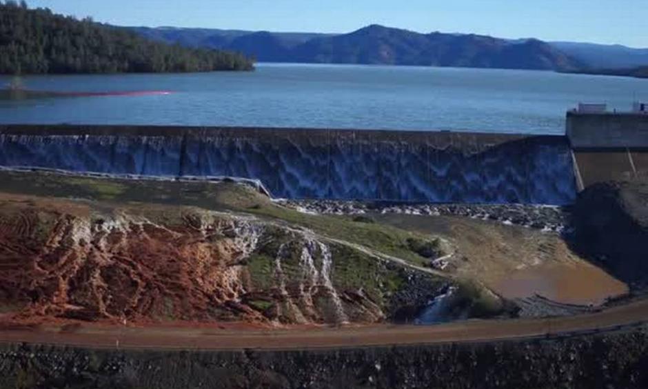 The Department of Water Resources released a video shot by a drone over the Oroville Dam. Water is seen running over the emergency spillway as well as the main spillway. Photo: Department of Water Resources