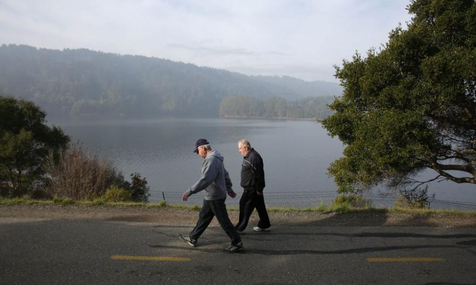 People walk along a path next to Crystal Springs Reservoir, which is starting to show a slow return to normal. Photo: Photo: Lea Suzuki, The Chronicle