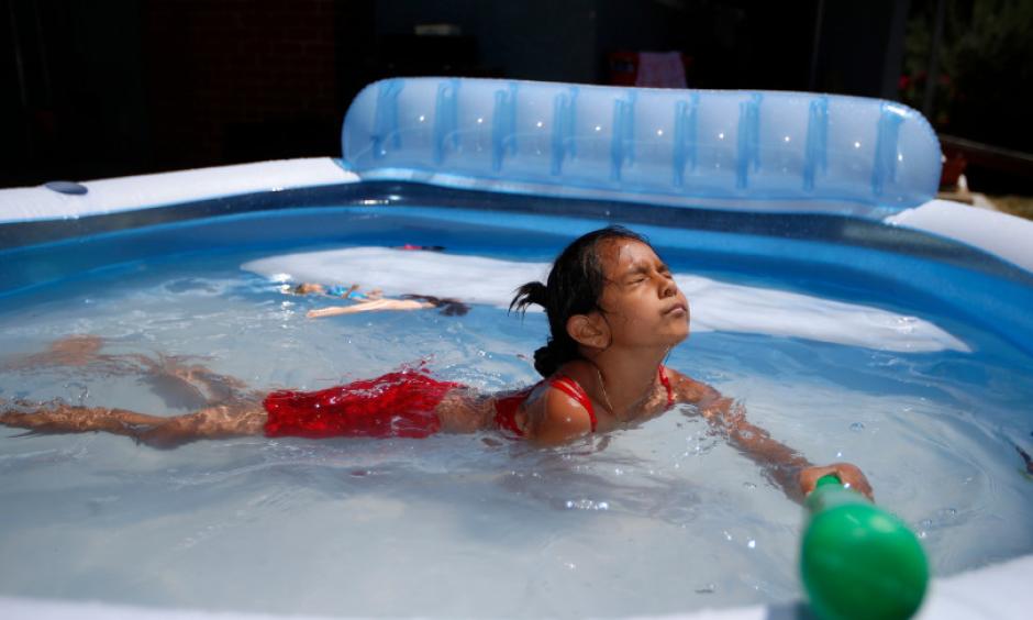 Windy Tinoco, 7, enjoys her family's outdoor inflatable pool in the front yard of their home in the Burbank neighborhood in San Jose, Calif., on Sunday, June 18, 2017. Photo: Nhat V. Meyer, Bay Area News Group