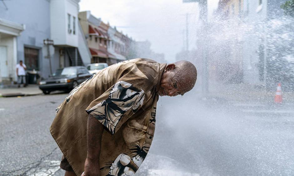 Eduardo Velev cools off in the spray of a fire hydrant in Philadelphia during a July 2018 heat wave. Scientists say last summer's extreme heat across the Northern Hemisphere wouldn’t have happened without human-induced climate change. Photo: Jessica Kourkounis, Getty Images