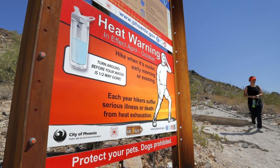 In this June 22, 2016 file photo, a sign warning of extreme heat is seen on a trailhead at Piestewa Peak in Phoenix. Thirty-one of the country’s top science organizations are telling Congress that global warming is real, a problem and something needs to be done about it. The science groups, which represent millions of scientists, sent the letter Tuesday, June 28, 2016, saying the severity of climate change is increasing and will get worse faster in coming decades. Photo: Matt York, AP