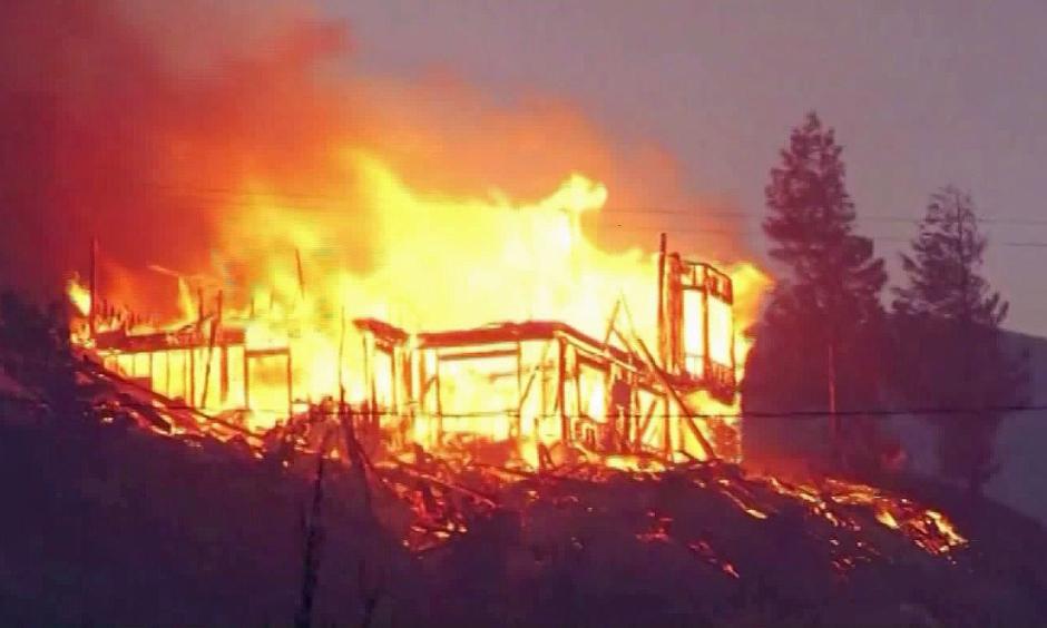Flames from the Erskine fire tear through a house in the Lake Isabella area. Photo: KBAK via CNN