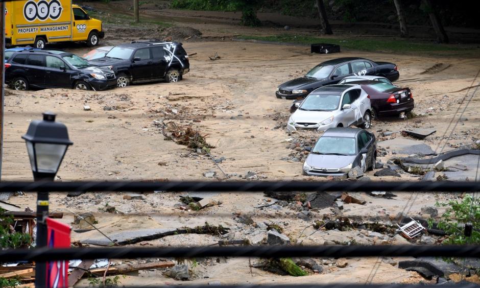 Destroyed parked cars are stranded in the mud May 28 in Ellicott City, Md. This comes two years after another flash flood killed two people and devastated the historic downtown. Photo: Katherine Frey, The Washington Post