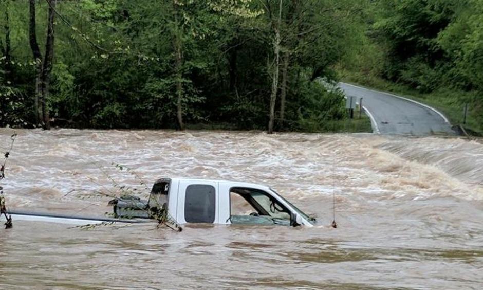 Rescuers found the driver of this truck on top of the vehicle when they arrived Monday morning in Wilkes County, North Carolina. Heavy rain is causing flooding in the Carolinas and Virginia. Photo: WXII/Bethany Moore