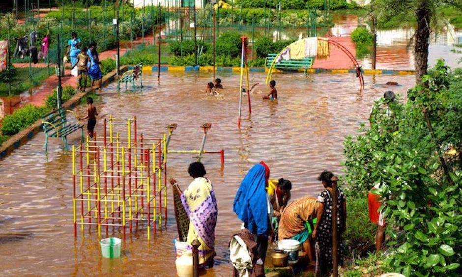 Children using a flooded playground as a swimming pool in Chennai. Photo: Ben Robinson