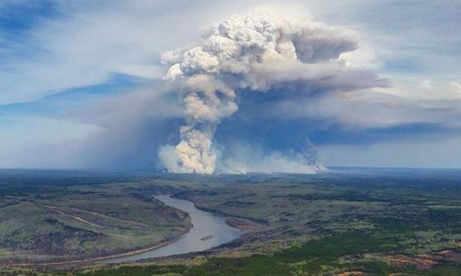 Smoke rises at Fort McMurray in Alberta, Canada on May 4, 2016. Pyrocumulus clouds formed by major wildfires can sometimes develop into pyrocumulunimbus clouds intense enough to generate lightning, hail, high winds, and tornadoes. Photo: @tamarackaspenbirch/Instagram