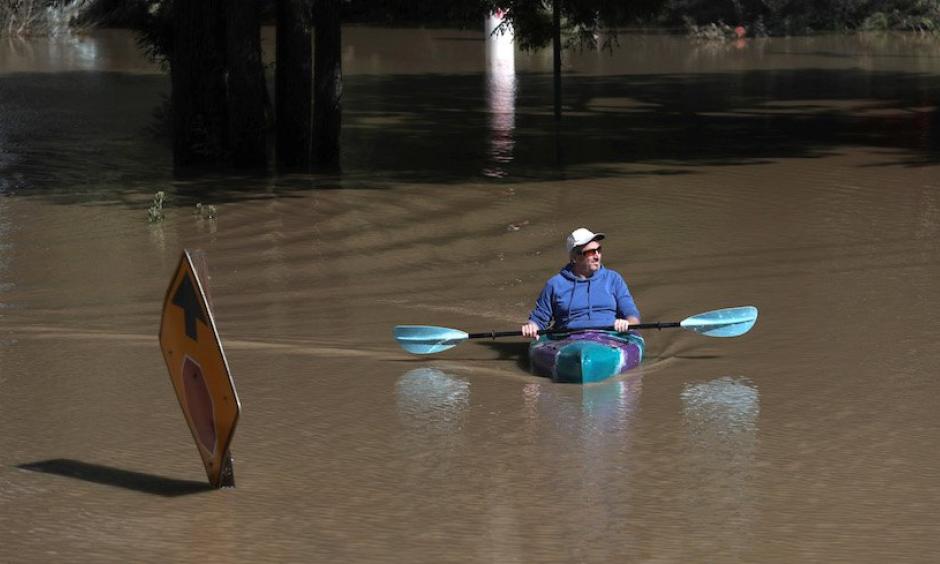 On the last day of meteorological winter—February 28, 2019—a kayaker paddles through a flooded neighborhood in Guerneville, California. The town was under mandatory evacuation and roads leading into the town have been flooded over, after an atmospheric river event brought torrential rains to central California and inundated the Sierra with heavy snow. Photo: Justin Sullivan, Getty Images