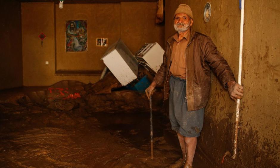A man stands in mud in the city of Mamulan in Iran's Lorestan Province. Heavy rain and unprecedented flooding has killed at least 70 people in Iran since mid-March. Photo: Hossein Mersadi, AFP/Getty Images
