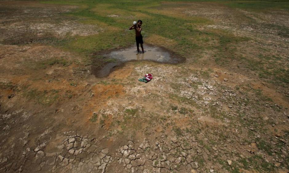 A village boy baths in the remaining water of a dried pond to beat the heat in the outskirts of the eastern Indian city of Bhubaneswar on April 23, 2016. Photo: Getty Images
