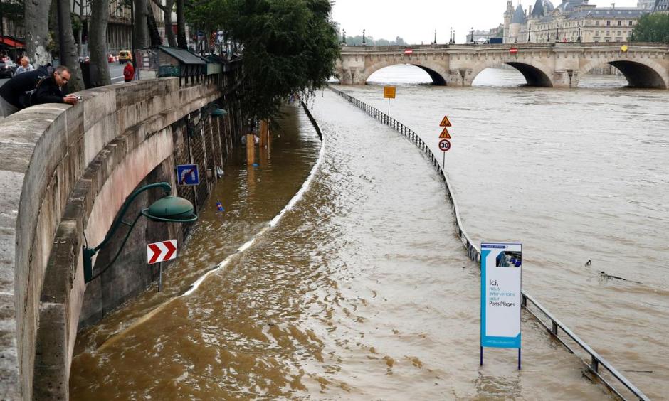 A man watches the flooded expressway along the Seine near the Pont Neuf (rear) after its banks became flooded, following heavy rainfalls on June 1, 2016 in Paris. Photo: Francois Guillot, AFP, Getty Images