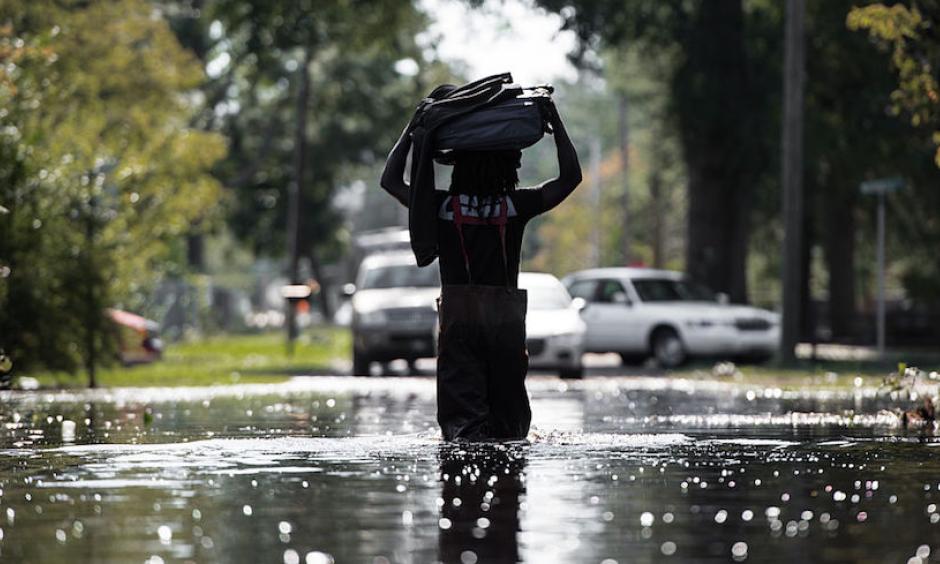 A man carries personal items through flooding associated with Hurricane Matthew on October 11, 2016, in Fair Bluff, North Carolina. Matthew, the Atlantic’s first Category 5 hurricane since 2007, left a trail of destruction from the Lesser Antilles to Virginia. Haiti was hardest hit, with more than 500 deaths and nearly $2 billion in damage. Photo: Sean Rayford, Getty Images