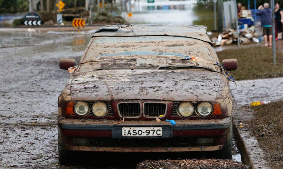 A car is seen on a central Lismore street on April 2, 2017 in Lismore, Australia. Heavy rain caused flash flooding in south east Queensland and Northern New South Wales as ex-cyclone Debbie made its way south across the country. Image credit: Photo: Jason O'Brien, Getty Images