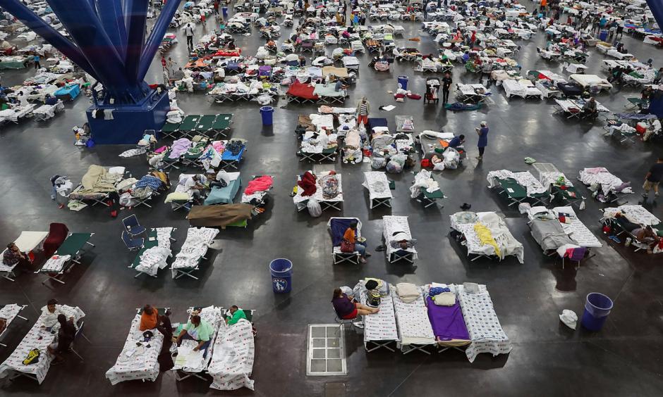 Evacuees fill up cots at a shelter set up inside the George R. Brown Convention Center in Houston, Texas. Photo: Joe Raedle, Getty Images