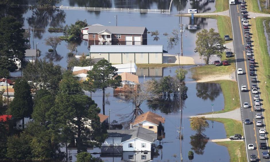 Floodwaters are seen surrounding homes after heavy rains from Hurricane Florence on September 20, 2018, in Lumberton, North Carolina. The rainfall from Hurricane Florence was a 1,000-year event. Photo: Joe Raedle, Getty Images