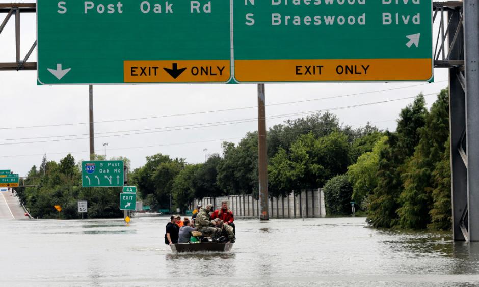 Residents are rescued from their homes surrounded by floodwaters from Tropical Storm Harvey on Sunday, Aug. 27, 2017, in Houston, Texas. Photo: David J. Phillip, AP