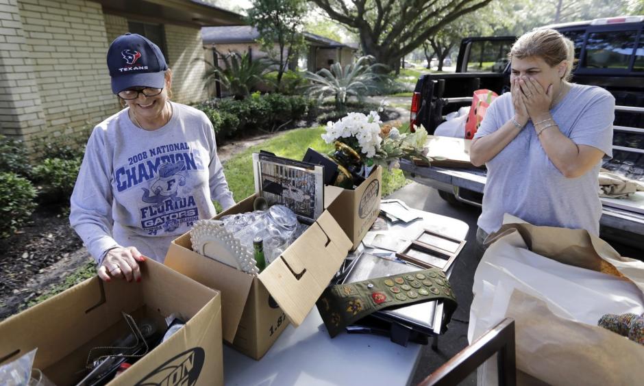 Judy Mellon, left, is helped by her daughter, Beth Kendrick, as she sorts through items damaged by floodwaters from Hurricane Harvey in Houston. Photo: David J. Phillip, AP