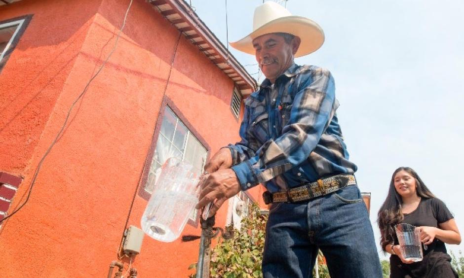 Homeowner Leonicio Ramirez and daughter Tania Ramirez are the first residents to receive water through a water distribution system in East Porterville, California, on Aug. 19, 2016. Engineers at the California Department of Water Resources designed a system to deliver water from the city of Porterville to 1,800 homes in its neighboring community to the east. Photo: Florence Low, California Department of Water Resources