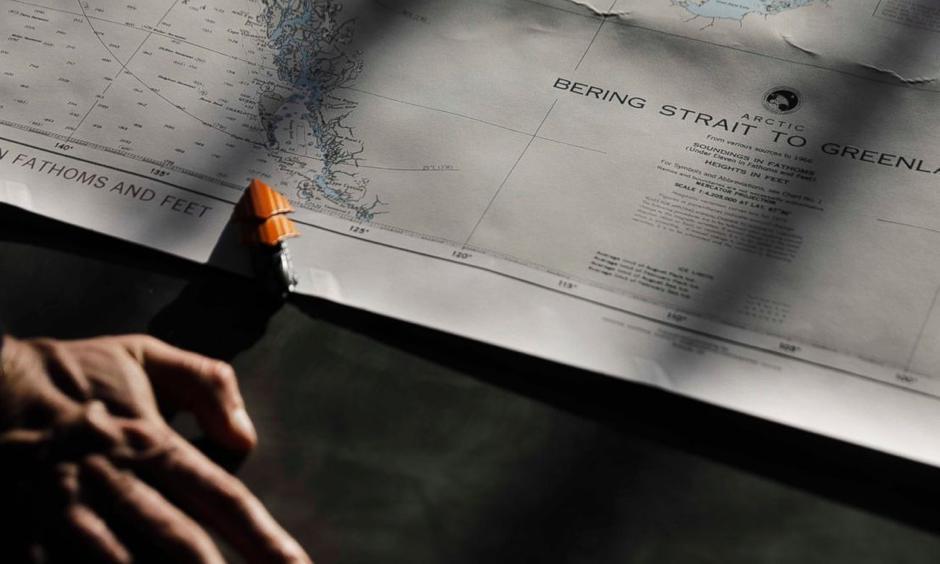 Polar maritime lawyer Scott Joblin, from the Australian National University in Cambria, looks over a map aboard the Finnish icebreaker MSV Nordica as it sets sail in the North Pacific Ocean toward the Bering Strait, Thursday, July 6, 2017. Photo: David Goldman, AP