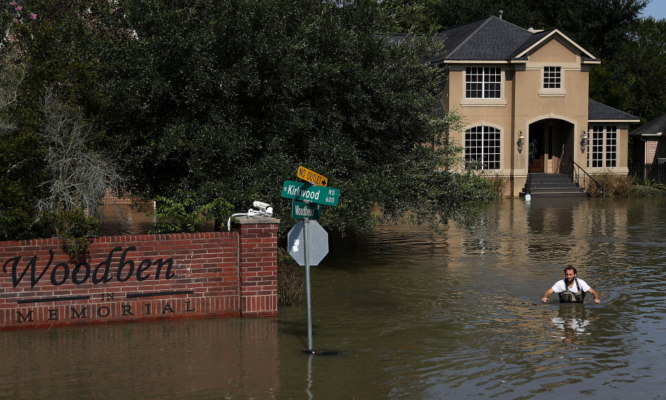 Chris Ginter wades through deep floodwaters on September 6, 2017 in Houston, Texas. Ginter, a Houston resident, has been taking local residents to their flooded homes in his monster truck which can drive through waters up to 4 feet deep. Photo: Justin Sullivan/Getty Images