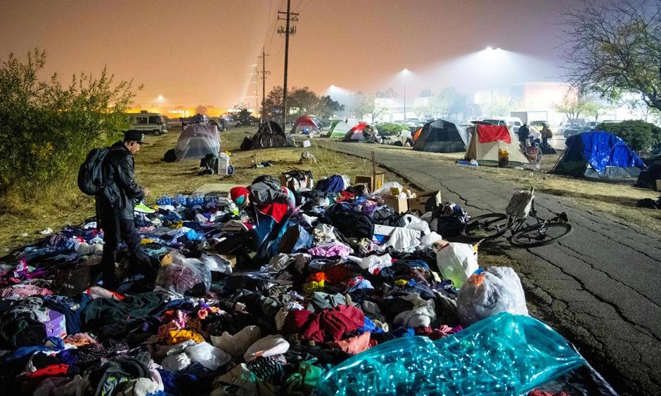 Evacuees sift through a pile of clothing at an encampment in a Walmart parking lot in Chico, California, on 17 November. Photo: Josh Edelson, AFP/Getty Images
