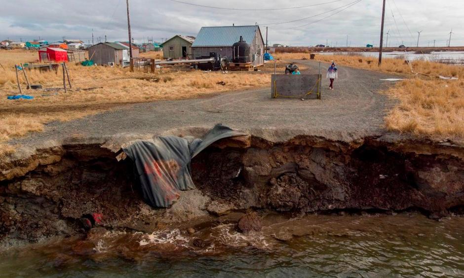 Climate change erosion caused by melting permafrost tundra and the disappearance of sea ice which formed a protective barrier, threatens houses from the Yupik Eskimo village of Quinhagak on the Yukon Delta in Alaska last month. Photo: Mark Ralston, AFP