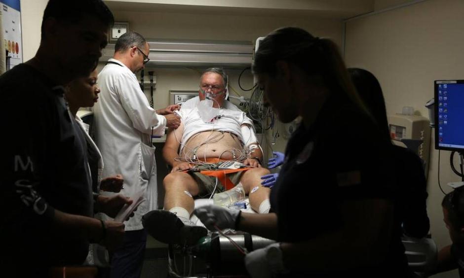 Doctor David Farcy works on David Patlak, acting as a cardiac arrest patient during an emergency drill, at Mount Sinai Medical Center's Emergency Room, July 24, 2015. Floridians are already experiencing the health effects of climate change, including heat stroke and heart problems, doctors say. Now some medical practitioners are banding together to educate and advocate for their patients as the Florida Clinicians for Climate Action. Photo: Emily Michot, Miami Herald