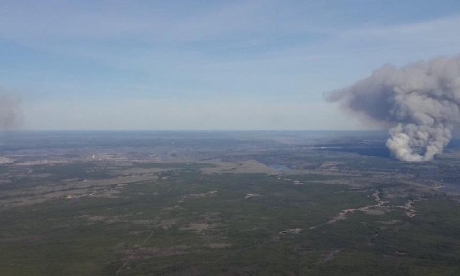 These two fires started at about the same time on May 1, 2016 near Fort McMurray, Alberta, Canada. Seen just after they started, on the left is the MMD-004 fire inside the city limits of Fort McMurray. The Horse River Fire, often referred to as the Fort McMurray Fire, is on the right. Alberta Forestry photo.