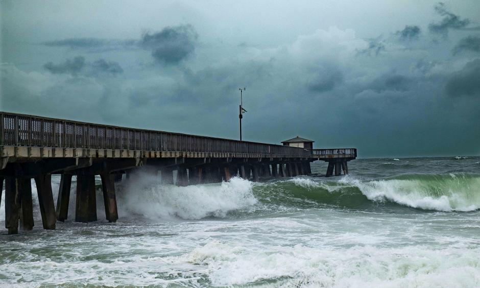 Waves pound a pier on Pompano Beach, Florida, spurred by Hurricane Matthew. The state is ill-prepared for rising seas, experts warn. Photo: Gaston de Cardenas, AFP Getty