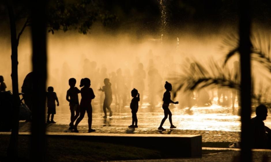 Children play as they cool down in a fountain beside the Manzanares river in Madrid, Spain. Photo: AP