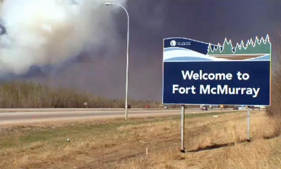 Wildfire smoke blankets the sky behind the 'Welcome to Fort McMurray' sign on May 18, 2016. Photo: CTV Edmonton